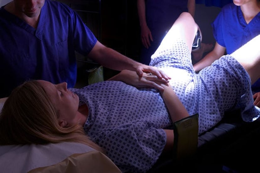 A woman lying down during a childbirth process