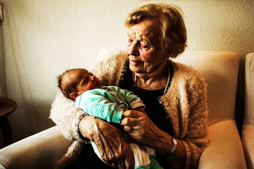 A grandmother holding her grandchild in her arms