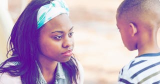 A mother looking sad while talking to her son