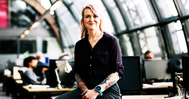 A tattooed 40-year-old woman at her office