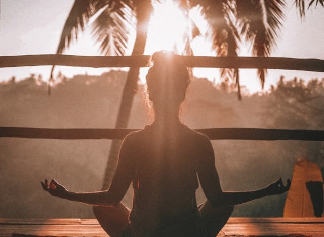 I don't care quotes, Woman meditating in front of a palm tree