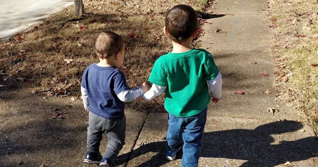 Stephanie Warden's sons walking while holding each other's hands who saved their mother's life