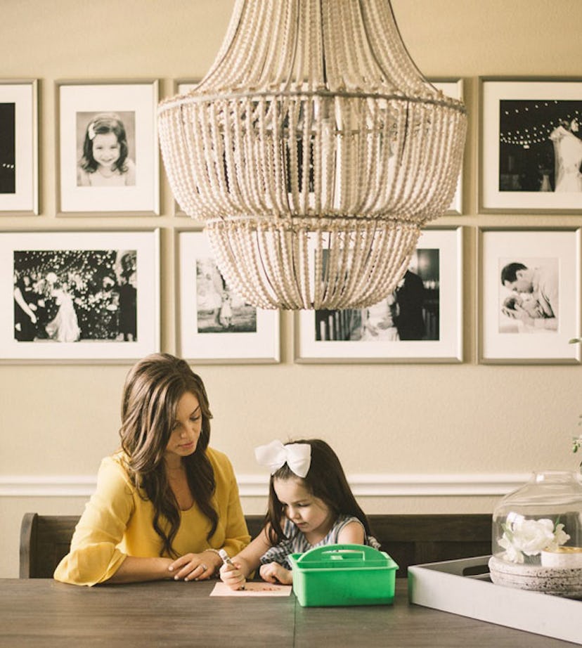 A stay-at-home mom helping her daughter with drawing   