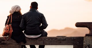 Cheap date ideas, Couple sitting on a bench at sunset