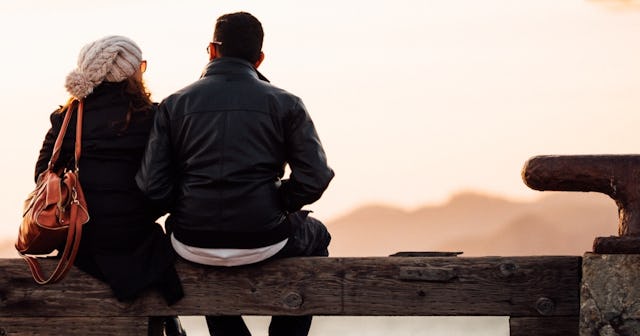 Cheap date ideas, Couple sitting on a bench at sunset