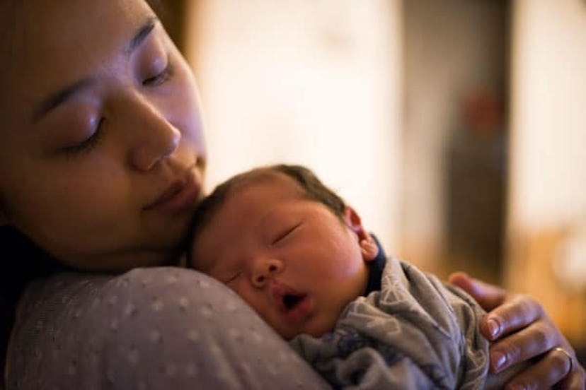 Why I Said No To Visitors For 2 Weeks After Giving Birth: A mother looks his newborn baby gently