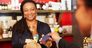 Black Women Are Starting Successful Businesses Faster Than Anyone Else: Black woman serving customer...