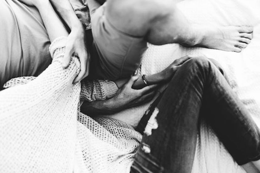 A woman who is a widow lying in bed and cuddling next to a man in black and white