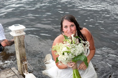 What Falling in a River on my Wedding Day Taught me About Motherhood: wet bride in river holding flo...