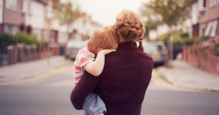 Young boy resting on mother's shoulde