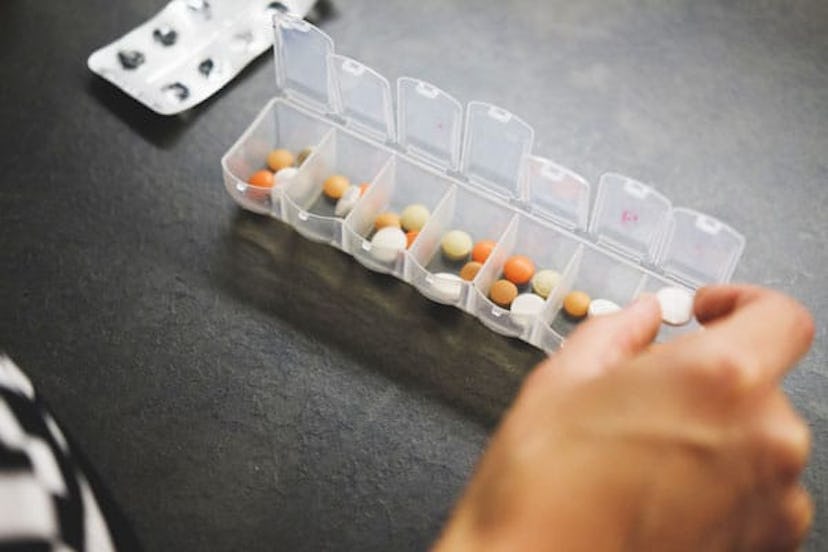 person opening pill case