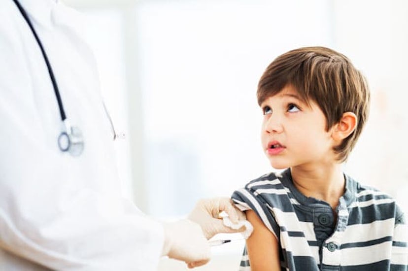 A doctor giving a vaccine to a boy