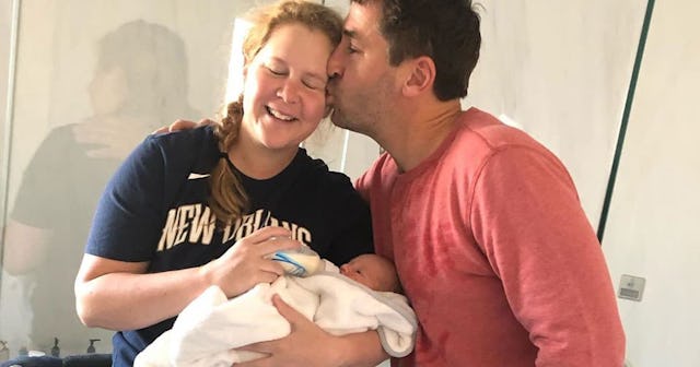 Amy Schumer Crying Over Her Baby's First Fever Is Relatable AF: Amy Schumer holding baby with husban...