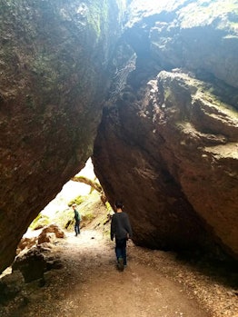 Two kids walking under rocks