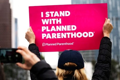 n activist seen holding a placard that says I Stand with Planned Parenthood