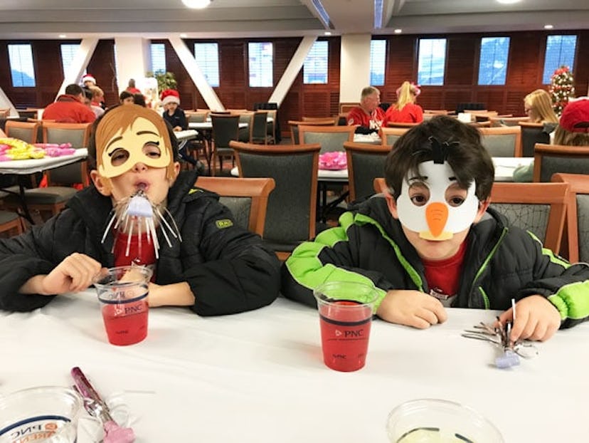 two children at table with masks on