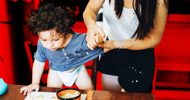 I Remember When My Home Was My Sanctuary: mom dressing son while he makes a mess