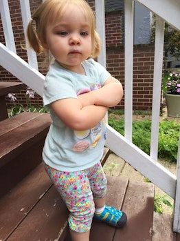 little girl on stairs with arms crossed