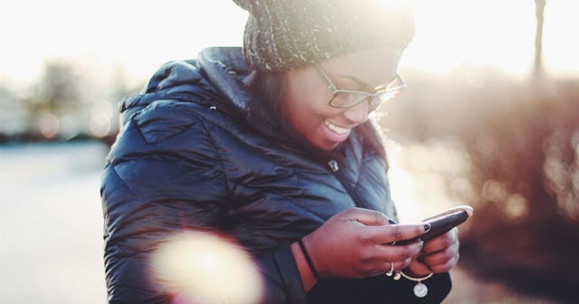 texting games, Woman texting and smiling
