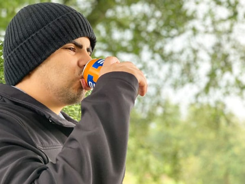 Katarina Garcia's husband with a grey beanie drinking juice from the can 