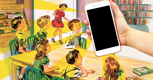 Kids in classroom staring at phone