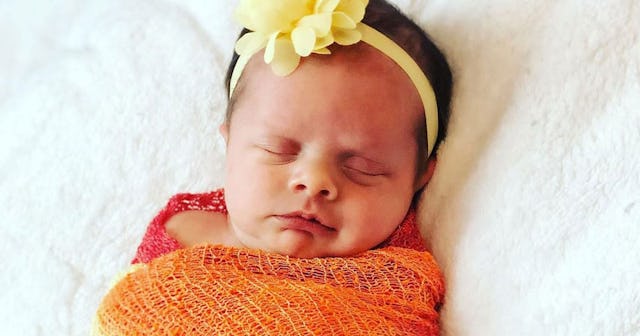 There's Something Special About A Rainbow Baby: Baby wrapped in rainbow blanket