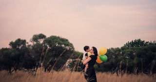 Mother and child in a field with balloons