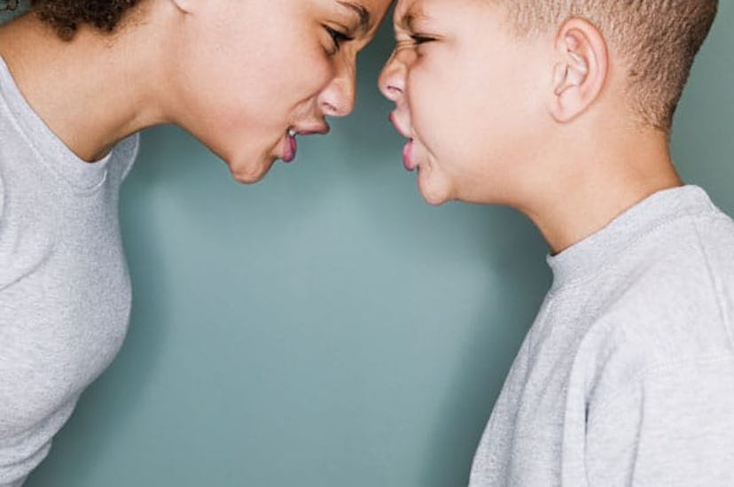 Teach Your Kids How To Deal With Confrontation: Boy and girl grimacing at one another