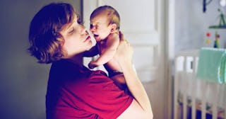 mother with crying newborn baby at home