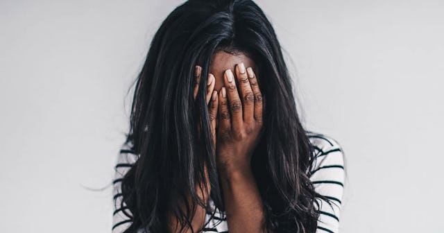 Woman covering her face