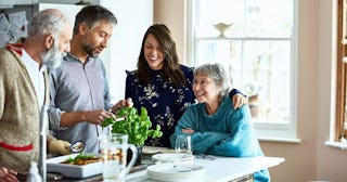 Couple hosting their parents and in laws for dinner in family home