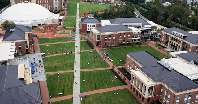Students mingle on the campus lawn at Liberty University