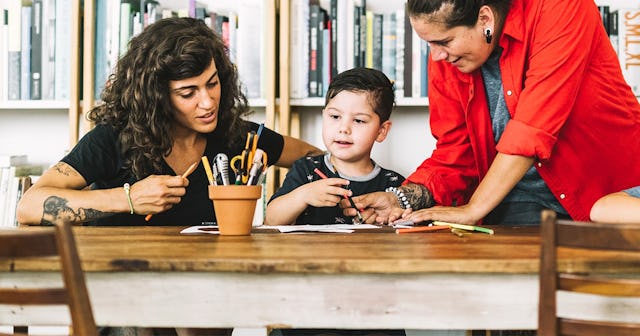 parents assisting children in drawing