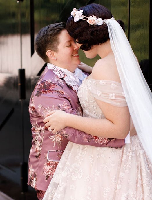 The Odds Are Against LGBT Couples: LGBT couple looking posing for camera at wedding