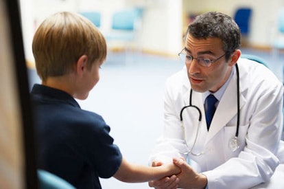 Doctor examining young boy
