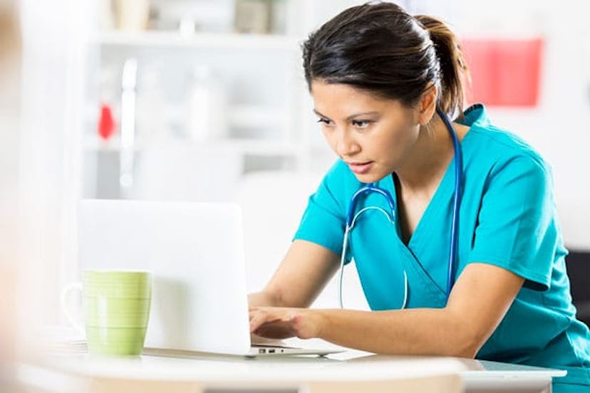 Female healthcare professional uses a laptop