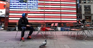 A man wears a protective mask as he sits in Times Square on March 12, 2020 in New York City.