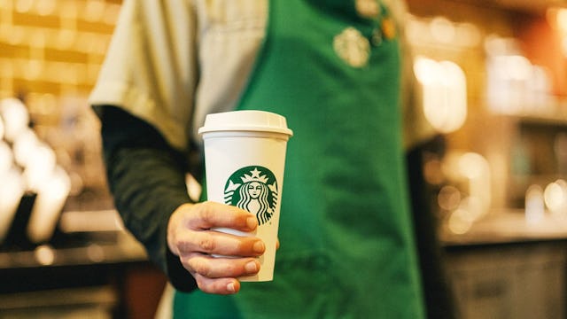 Employee at Starbucks serving drink