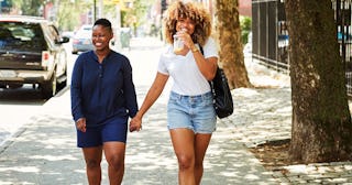 Why We Hold Hands With The People We Love: women holding hands on city sidewalk