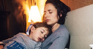 Child sleeping in mothers arms