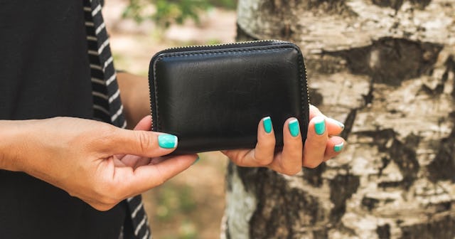 what to do if you lose your wallet, Woman holding a wallet