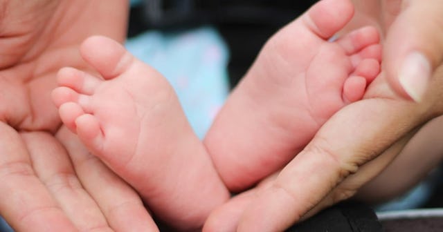 closed adoption, adult holding baby feet