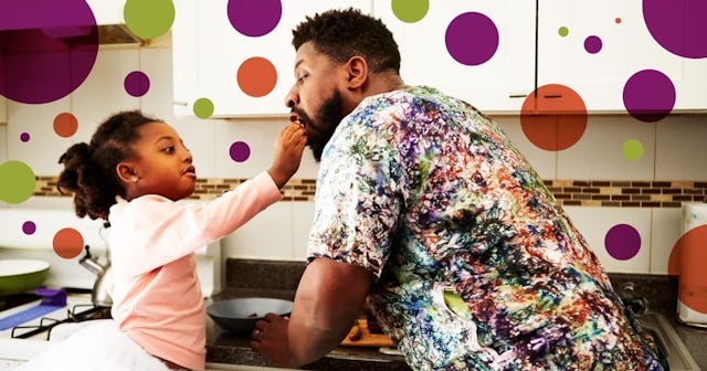 Girl feeding father in kitchen