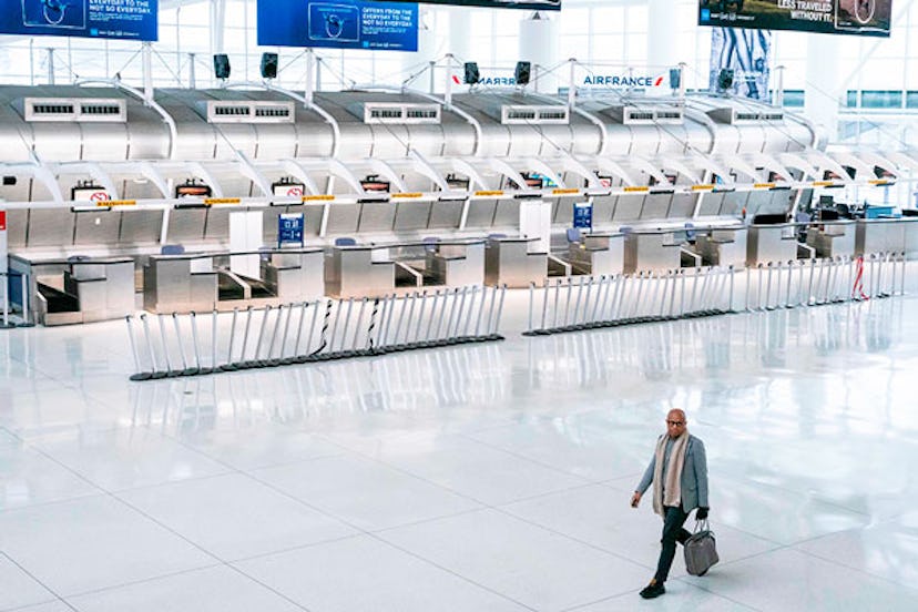 A man walks past the closed Air France counters at the Terminal 1 section at John F. Kennedy Interna...