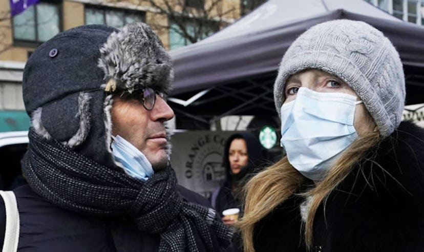 Tourists wearing masks walk through Union Square in New York City on February 28, 2020, amid fears o...