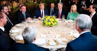 US President Donald Trump (C) speaks with Brazilian President Jair Bolsonaro (L), alongside United S...