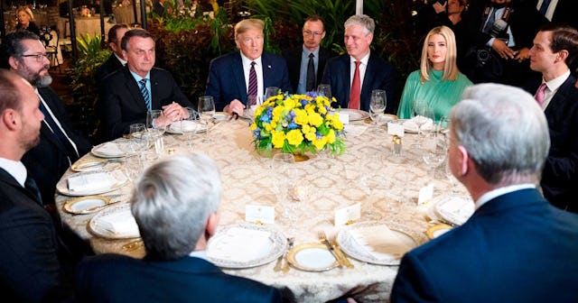 US President Donald Trump (C) speaks with Brazilian President Jair Bolsonaro (L), alongside United S...