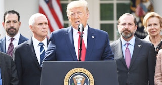 Surrounded by members of the White House Coronavirus Task Force, US President Donald Trump speaks at...