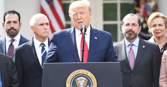 Surrounded by members of the White House Coronavirus Task Force, US President Donald Trump speaks at...