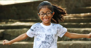 Girl child very happy having fun outdoors